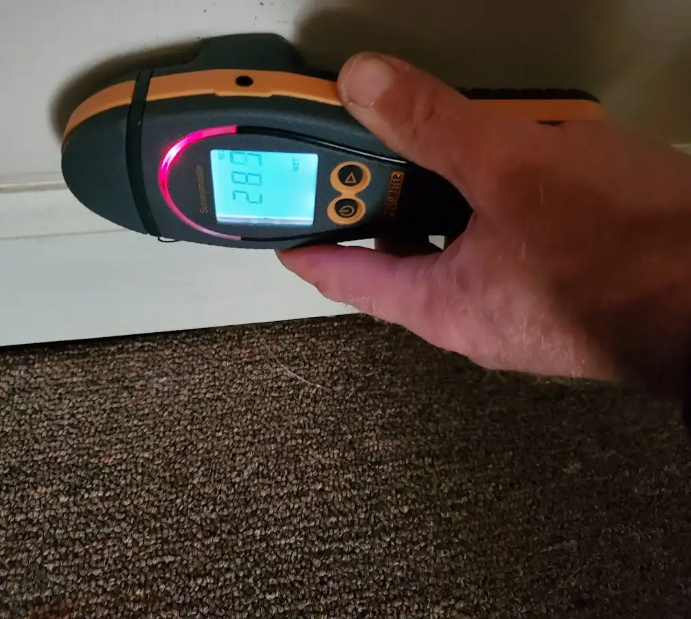 Moisture detection at baseboard during Storm Damage Restoration in College Station